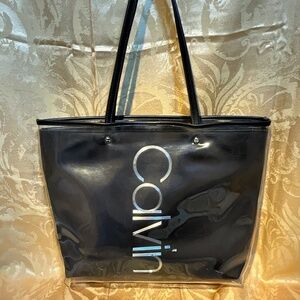 Calvin Klein large tote bag. Dark gray/black with plastic cover. 13- H9